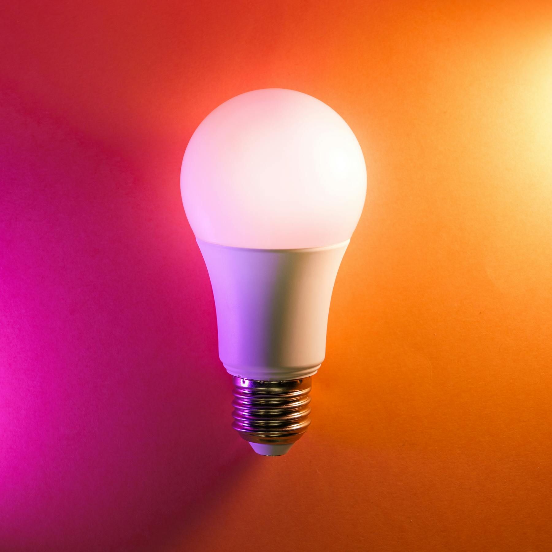 LED bulb on colourful gradient background