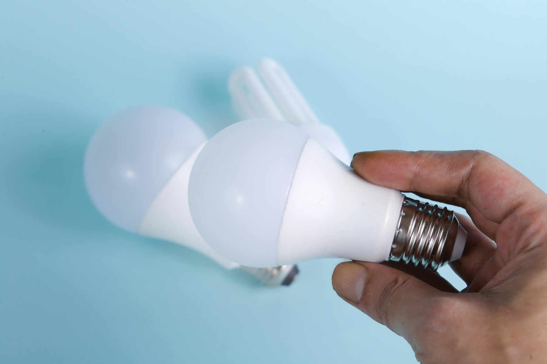Person Holding White Light Bulb