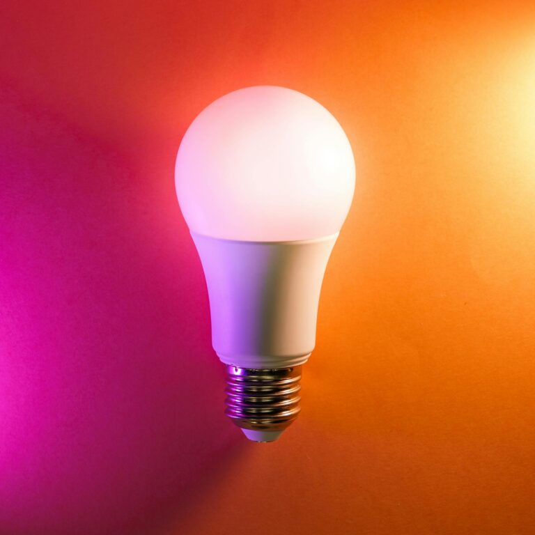 LED bulb on colourful gradient background